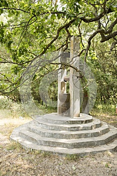 Old stone fountain,  from the forest near Letea village,  in the Danube Delta area,  Romania,  in a sunny summer day