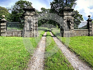 Stone gate entrance, with alcoves, leading through the trees in, School Lane, Laneshaw, Colnde, UK photo