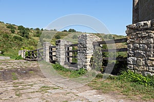 Old stone gate on the road to the ruins of a medieval fortress Khotyn. Ukraine