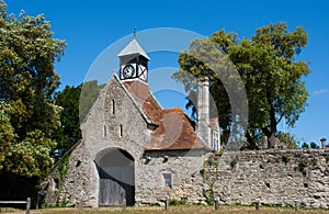 Old stone gatehouse with Tudor Clock Tower at the entrance to Beaulieu Abbey in the New Forest in the south of England