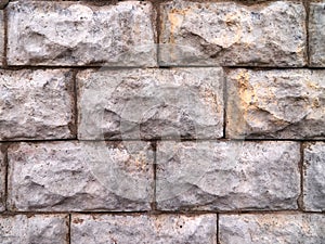 Old stone gray wall of bricks and concrete.