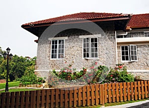 Old stone house with garden and fence