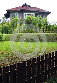 Old stone house with terraced garden and fence