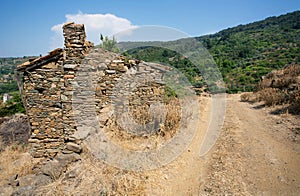 Old stone house in traditional turkish village with dirt road