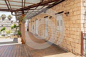 An old stone house with wooden windows on one of the quiet streets near the main pedestrian HaMeyasdim in Zikhron Yaakov city in