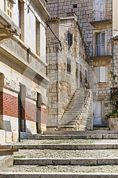 Old stone houses in a charming alley, typical Mediterranean architecture, island Vis, Komiza, Croatia