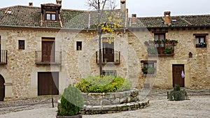 Old stone houses with wooden doors and windows in the medieval village of Pedraza, Segovia.