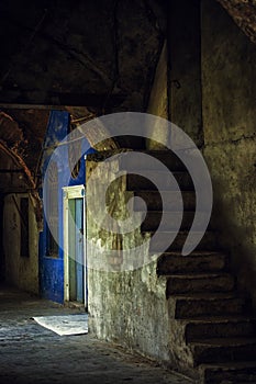 Old stone ladder and blue door