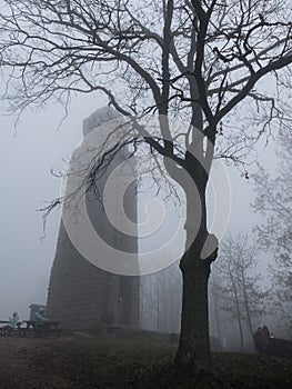 Old stone lookout tower in the fog