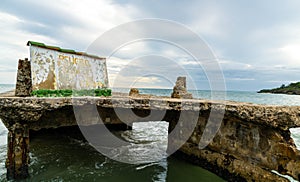 Old Stone Ocean Pier under Dramatic Sky
