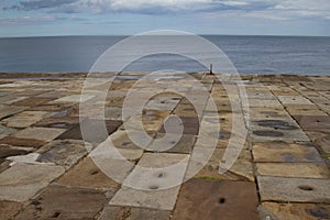 An old stone pier on the coastline