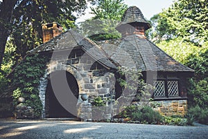 Old stone pumphouse in tudor revival architecture