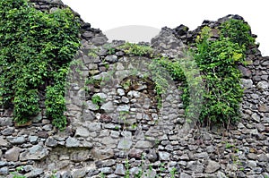 Old stone ruins on a background of green grass