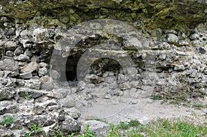 Old stone ruins on a background of green grass