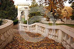 Old stone staircase with fallen leaves in park autumn