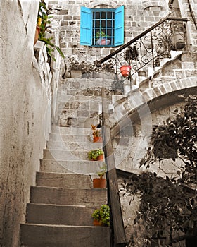 Old stone stairs and blue window