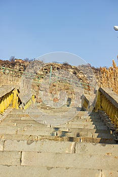 Old stone stairs wit yellow side cranks