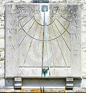 Old stone sundial on wall