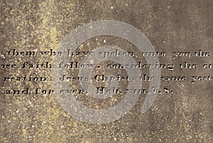 Old stone surface with the engraved words from Hebrews