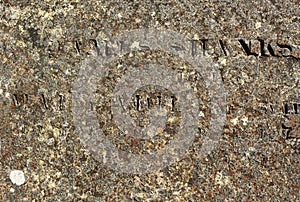 Old stone surface with partly readable engraved Latin letters