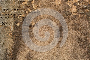 Old stone surface with partly readable Latin letters