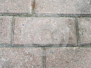 Old stone tile on street pavement close up