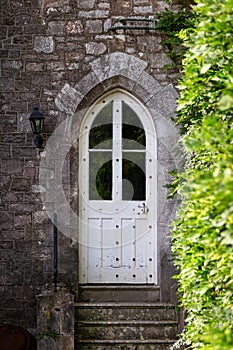 Old stone townhouse or castle arched door with stairs