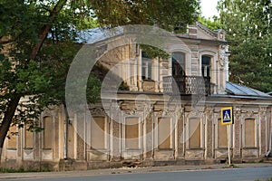 Old stone tumbledown house in russian provincial town at sunset