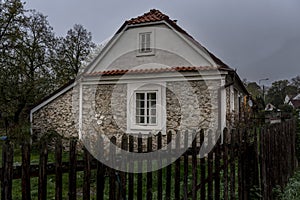 Old stone village house with white windows