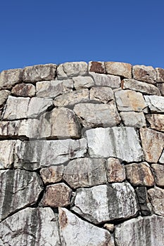 Old stone wall against blue sky