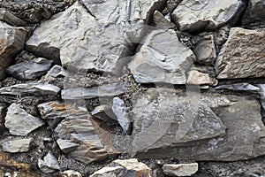 An old stone wall brown large stones. Classical masonry walls of medieval castles in Europe.