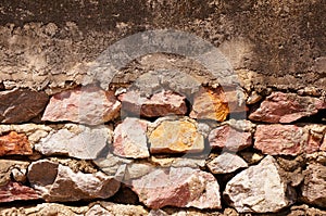 Old stone wall with cement floor