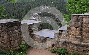 Old stone wall close-up overlooking the forest, the ruins of an old castle