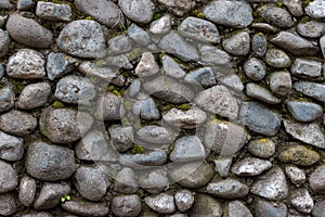 Old stone wall covered with clumps of green moss and lichen