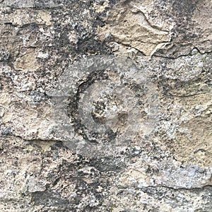 Old stone wall with cracks. Textural abstract background.