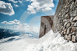 Old stone wall fortress castle on top of a snow mountain