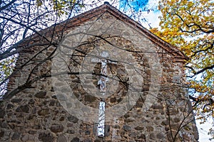 An old stone wall with a large cross on it. The chapel where Alexander Griboyedov and Princess Nina Chavchavadze were married