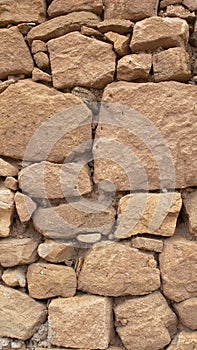 Old stone wall made without cement between the stones
