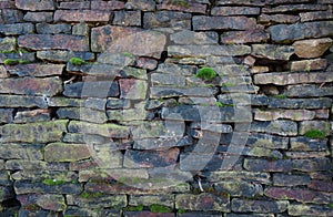 Old stone wall with moss and cobwebs