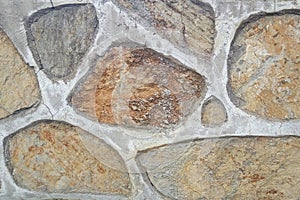 Old stone wall. Rough stones of different shapes. Stone background.