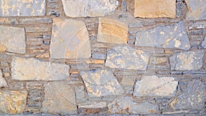 Old stone wall. Rough stones of different shapes. Stone background.