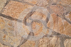 Old stone wall. Rough stones of different shapes. Stone background.