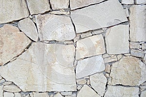 Old stone wall. Rough stones of different shapes. Stone background.