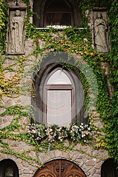 Old stone wall with a wedding decorated window