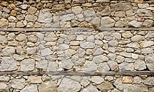 Old stone wall with wooden beams