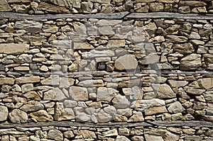 Old stone wall with wooden beams close