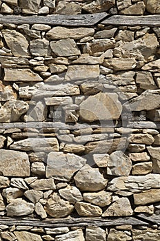 Old stone wall with wooden beams close