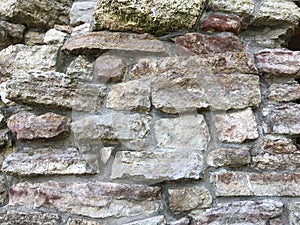 The old stone walls of the medieval structure, stone restoration, conservation of historic stone architecture, stones in the const