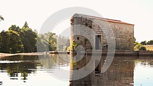 Old stone water mill on Ave River in rural Portugal.