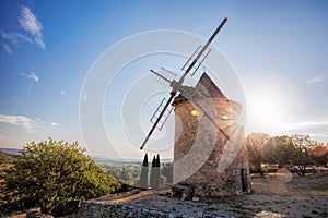 Old stone windmill against sunset in Saint Saturnin les Apt, Provence, France